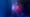 Profil d’un homme face à un écran vertical lumineux, dans l’obscurité, avec un éclairage bleu et magenta sur le visage.