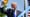 Donald Trump en costume sombre et cravate bleue lève le poing devant un microphone, en extérieur. Un bandeau bleu porte la mention « Partie 1 ».